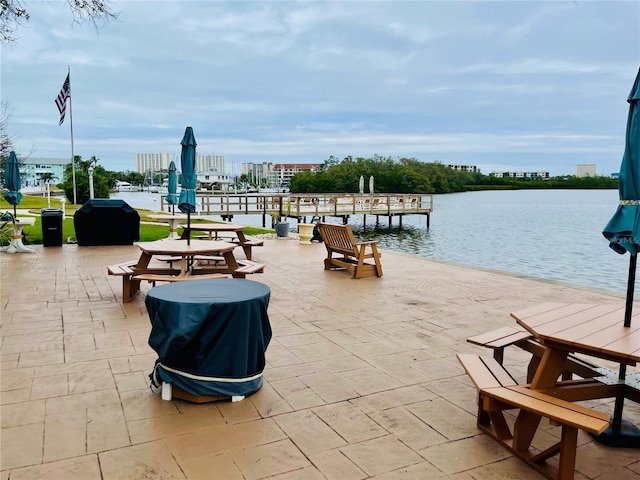 view of patio with a water view and area for grilling