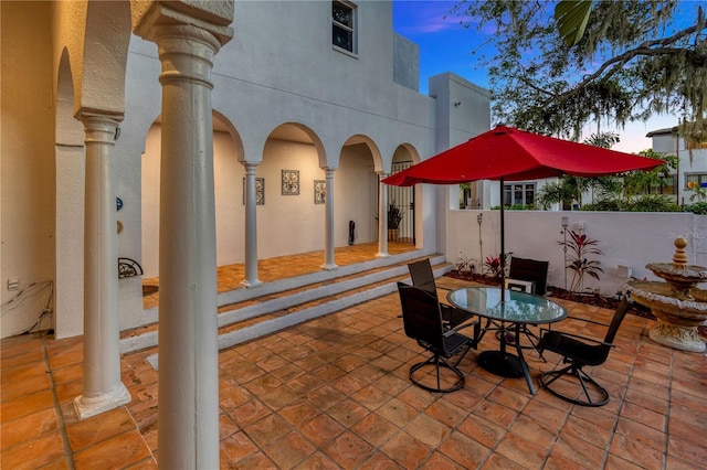 view of patio terrace at dusk