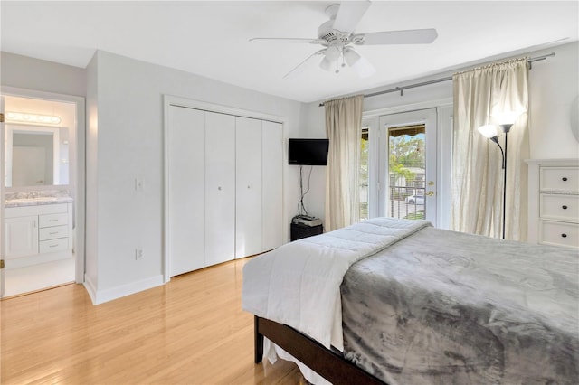 bedroom featuring ceiling fan, light hardwood / wood-style floors, access to outside, sink, and a closet