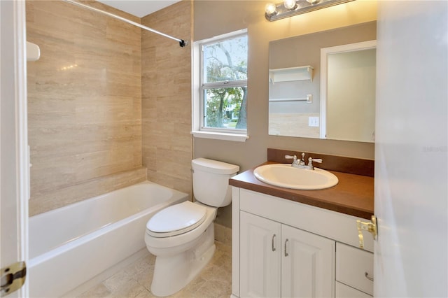 full bathroom featuring toilet, tile patterned flooring, tiled shower / bath, and vanity