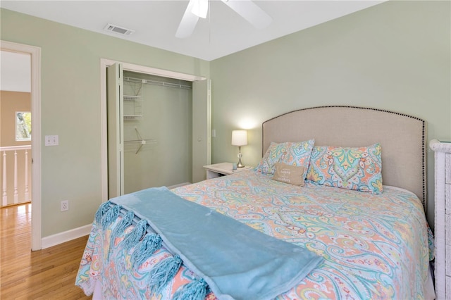 bedroom featuring ceiling fan, a closet, and light hardwood / wood-style flooring