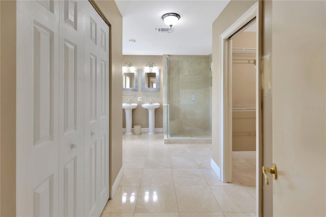 hall featuring light tile patterned flooring