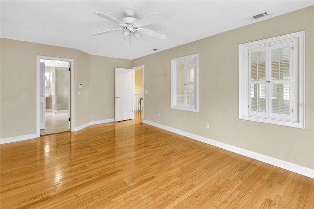 empty room featuring ceiling fan and light hardwood / wood-style flooring