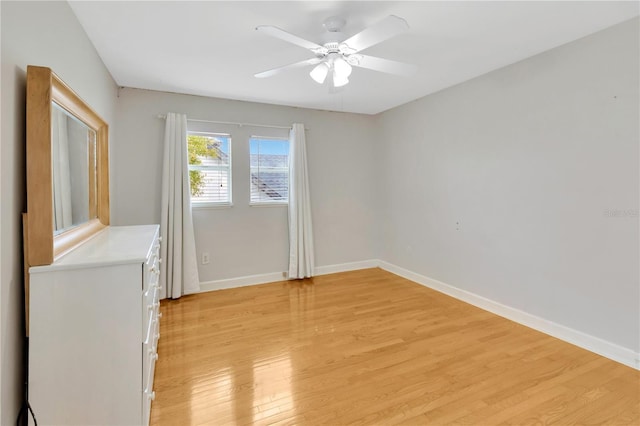 spare room featuring ceiling fan and light hardwood / wood-style flooring