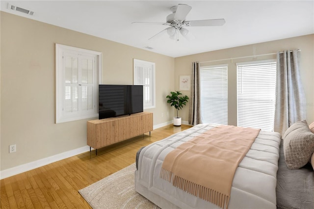 bedroom with light hardwood / wood-style floors and ceiling fan