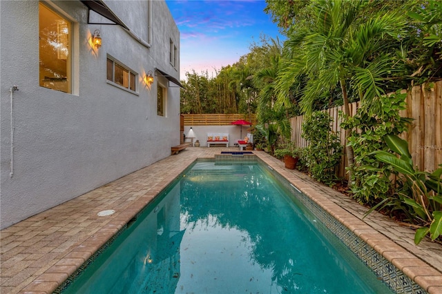 view of pool at dusk