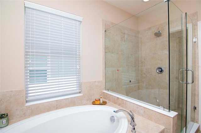 full bathroom featuring a stall shower and a garden tub