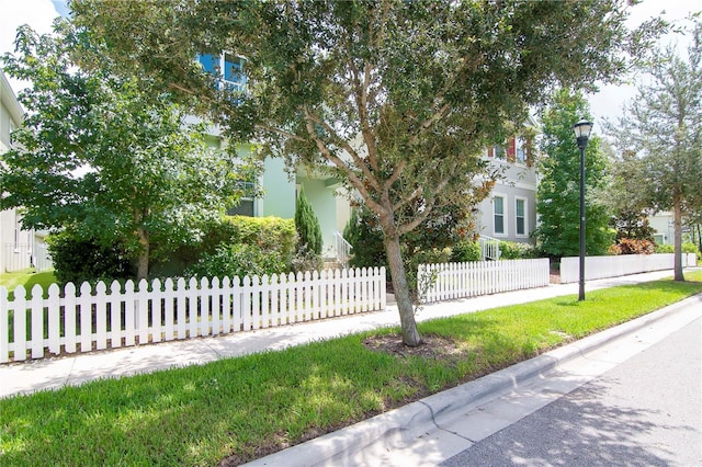 view of front of property with a fenced front yard and stucco siding