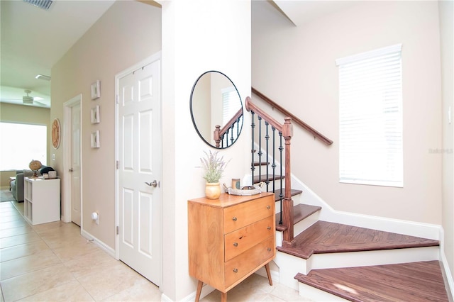 foyer featuring visible vents, stairway, baseboards, and light tile patterned floors