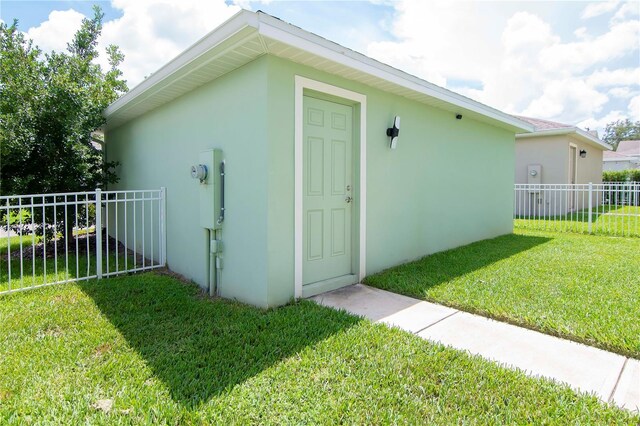 view of outbuilding featuring an outbuilding and fence