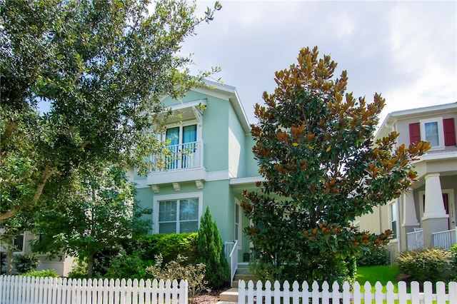 view of front facade with a fenced front yard and stucco siding