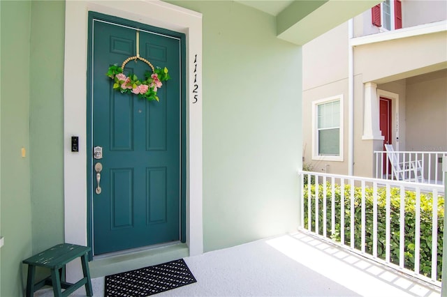 property entrance featuring stucco siding