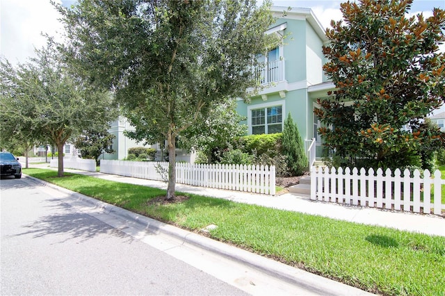 view of front facade with fence and stucco siding