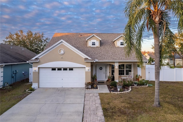 view of front facade featuring a garage and a yard