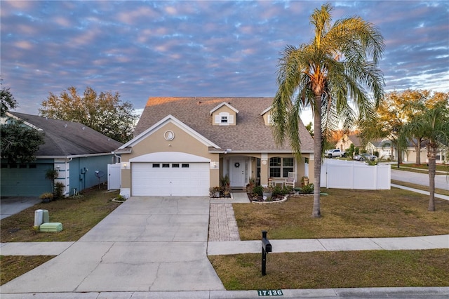 view of front facade featuring a yard and a garage