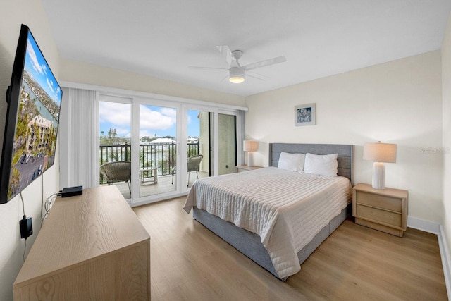 bedroom with baseboards, light wood-style floors, a ceiling fan, and access to exterior