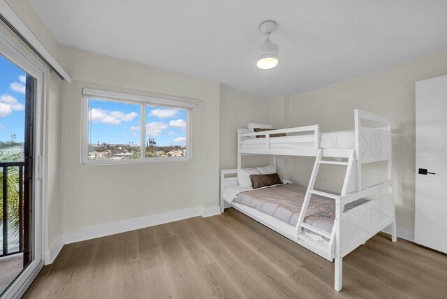 unfurnished bedroom featuring wood finished floors and baseboards