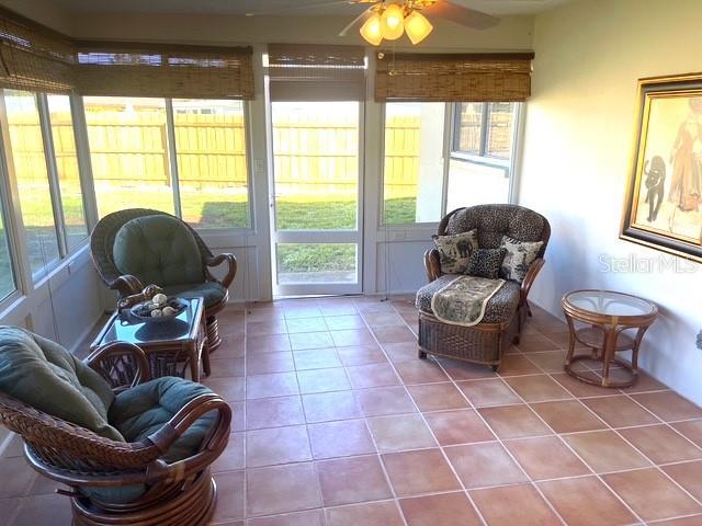 sunroom / solarium with ceiling fan and plenty of natural light