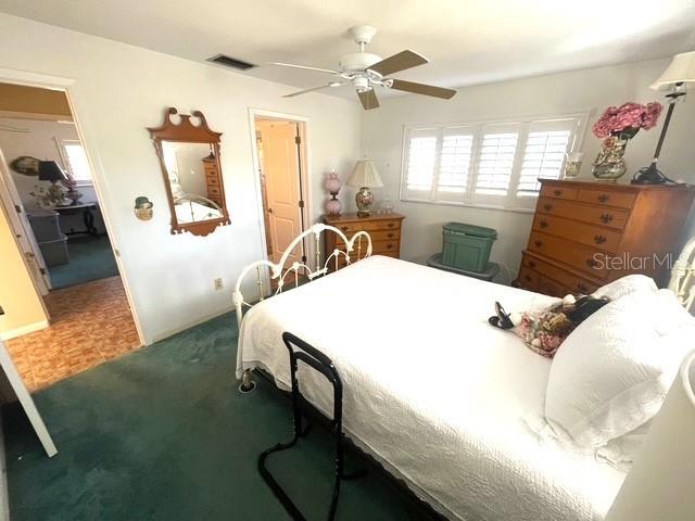 bedroom featuring parquet floors and ceiling fan