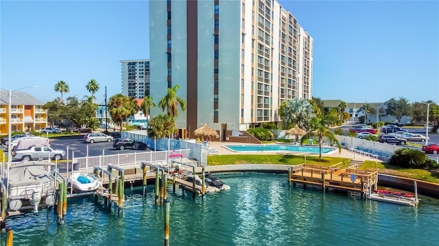 exterior space featuring a community pool and a water view