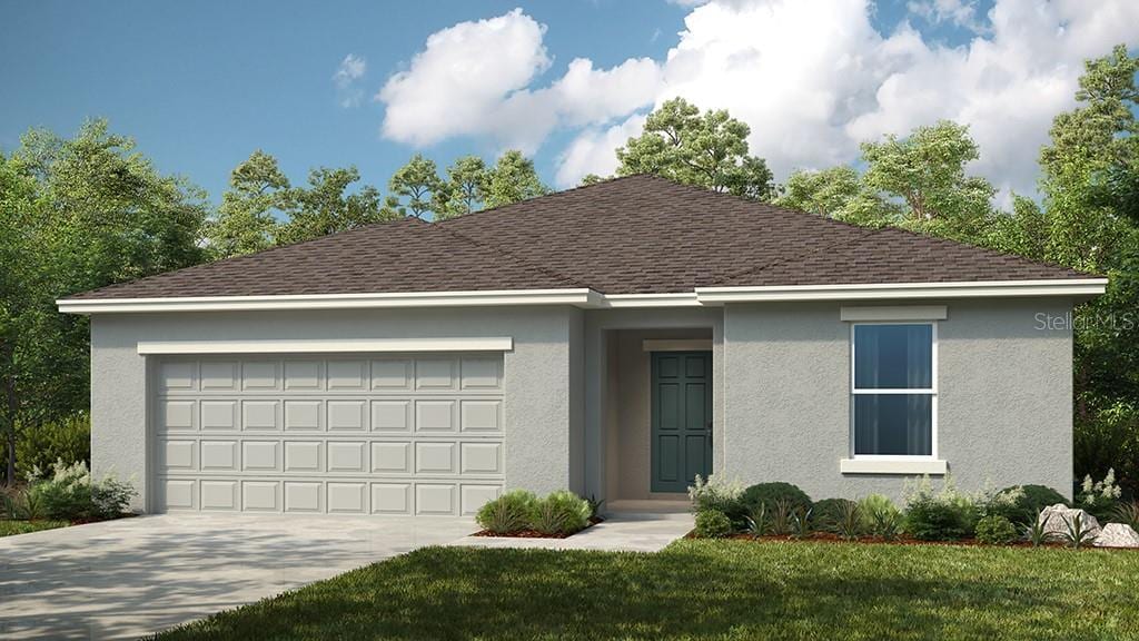 view of front of home with a garage and a front lawn