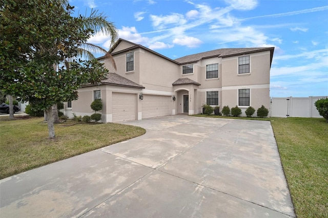 view of front of house with a garage and a front lawn