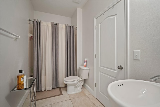 bathroom featuring tile patterned floors, toilet, and shower / bath combo