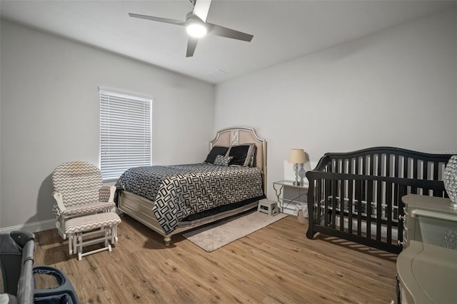 bedroom with ceiling fan and hardwood / wood-style flooring