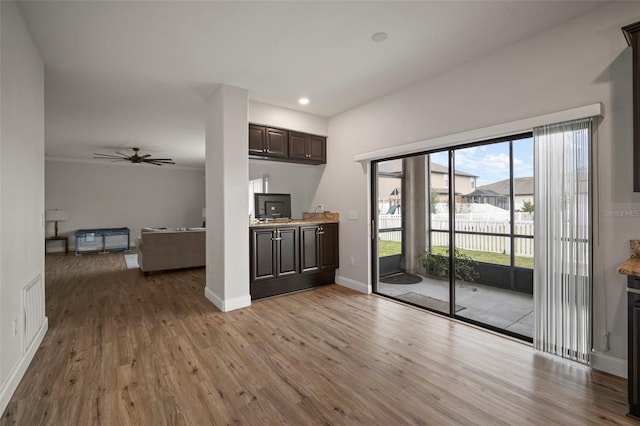 unfurnished living room featuring ceiling fan and light hardwood / wood-style flooring