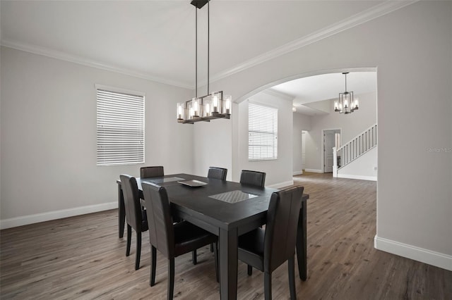 dining space featuring an inviting chandelier, dark wood-type flooring, and crown molding