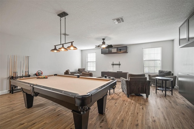 recreation room with ceiling fan, hardwood / wood-style floors, pool table, and a textured ceiling