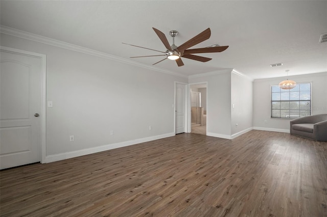 spare room featuring dark wood-type flooring, crown molding, and ceiling fan with notable chandelier