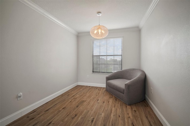 sitting room featuring hardwood / wood-style flooring and ornamental molding