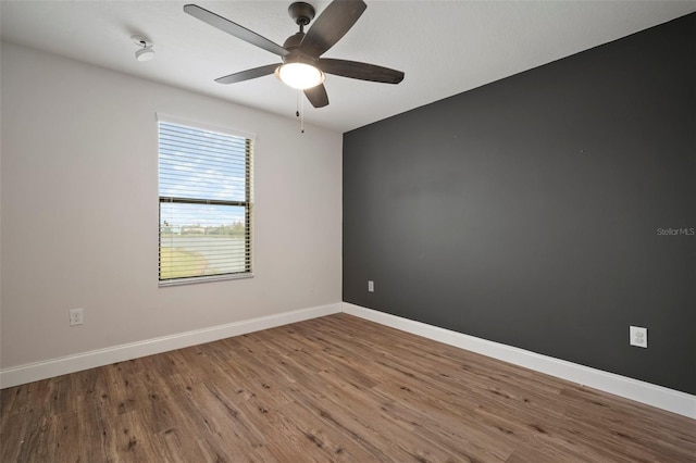 unfurnished room with ceiling fan and wood-type flooring