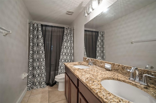 bathroom with tile patterned floors, vanity, and toilet