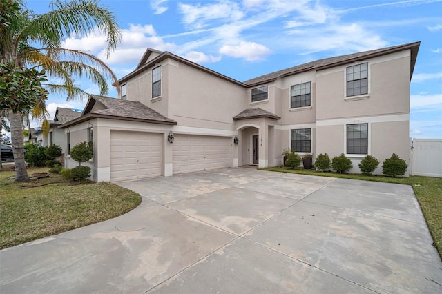 view of front property featuring a front yard and a garage