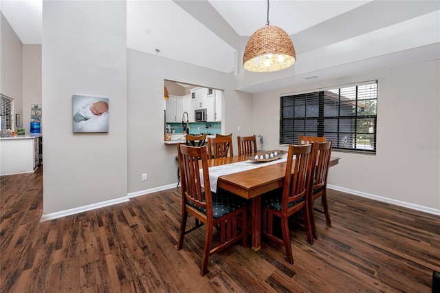 dining space featuring dark hardwood / wood-style floors and high vaulted ceiling