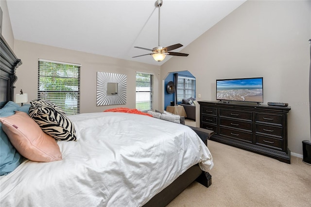 bedroom featuring lofted ceiling, light colored carpet, and ceiling fan