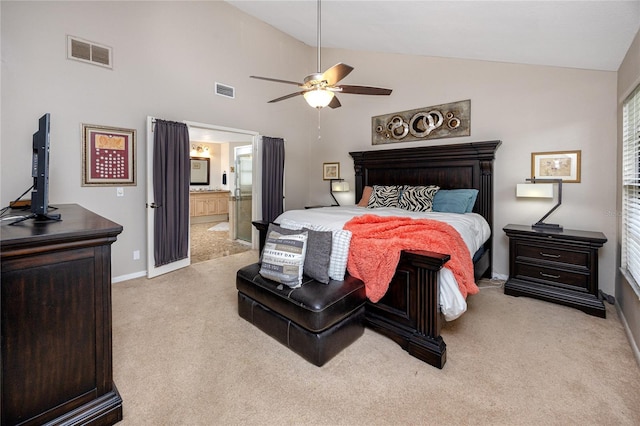 carpeted bedroom featuring ceiling fan, lofted ceiling, and ensuite bathroom