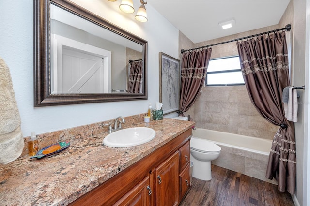 full bathroom with vanity, hardwood / wood-style flooring, toilet, and shower / bath combo with shower curtain