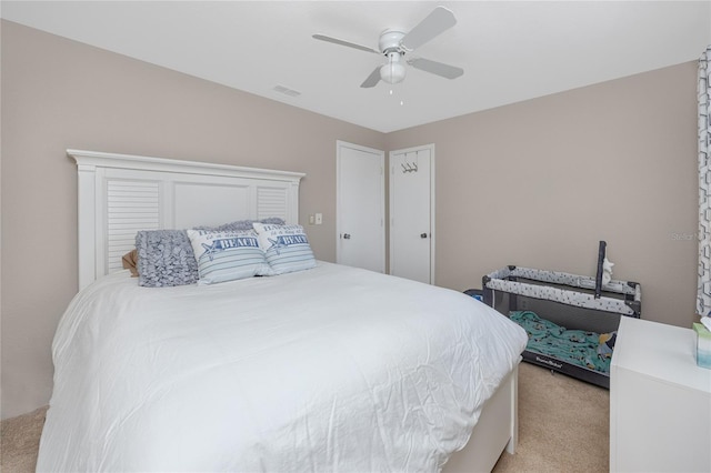 bedroom with light carpet and ceiling fan