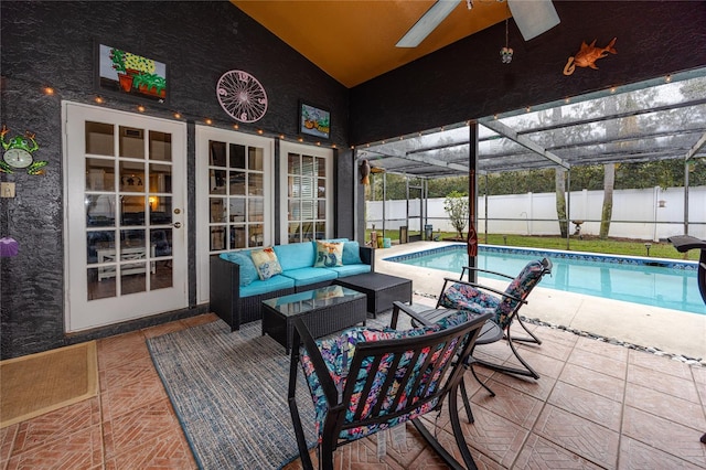 view of pool featuring a patio area, an outdoor hangout area, ceiling fan, and glass enclosure