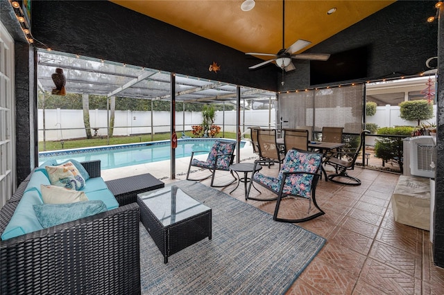 view of patio / terrace with a fenced in pool, a lanai, outdoor lounge area, and ceiling fan