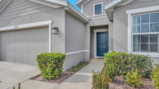 view of exterior entry with a garage