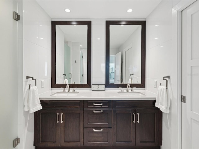 bathroom featuring vanity, tile walls, and walk in shower