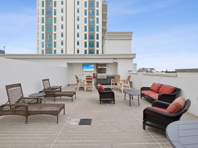 view of patio with an outdoor living space and a grill