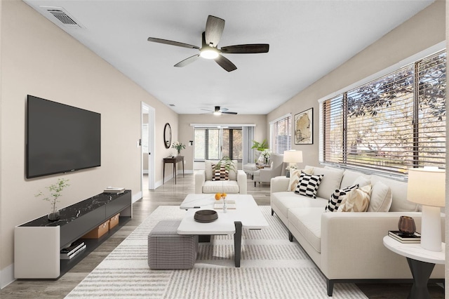 living room with hardwood / wood-style floors and ceiling fan