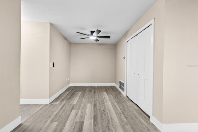 unfurnished bedroom with a closet, ceiling fan, and light hardwood / wood-style flooring