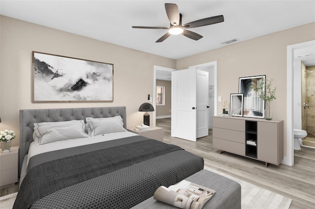 bedroom with ceiling fan, light hardwood / wood-style floors, and ensuite bathroom