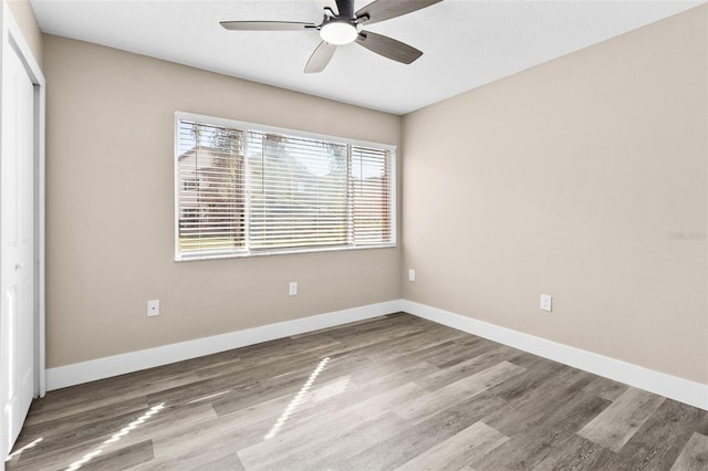 spare room featuring ceiling fan and hardwood / wood-style flooring